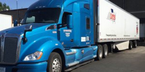 A DTS semi tractor and reefer trailer unit pulled up to a loading dock at a temp-control warehouse in Billings, Montana.